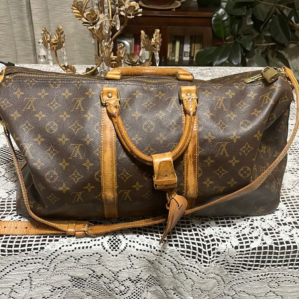 Authentic Louis Vuitton duffel.  Tag, strap and lock and key included.